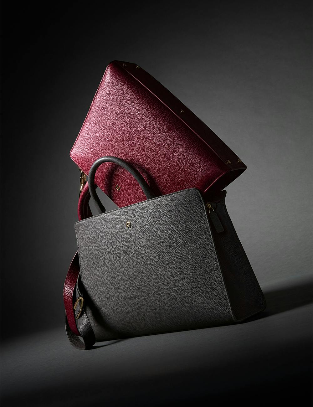 Two Cybill Bags stacked on top of eachother with a dark background